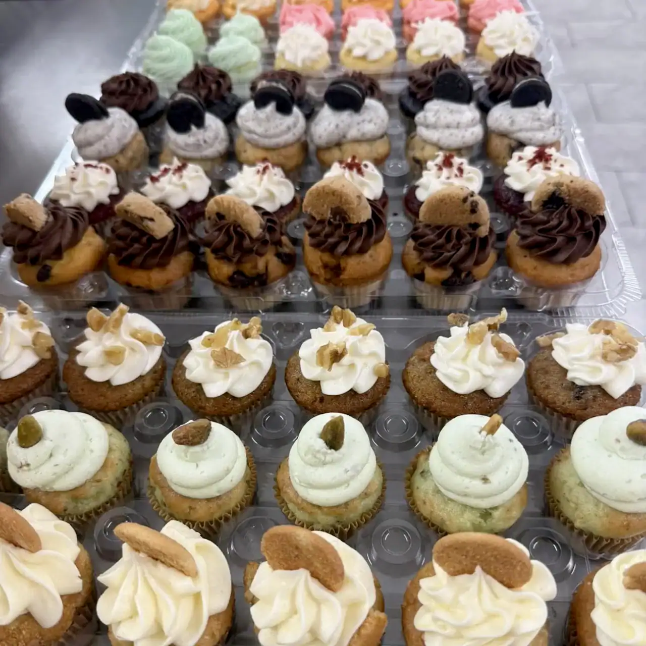 Cupcake Assortment with various frosting and toppings.