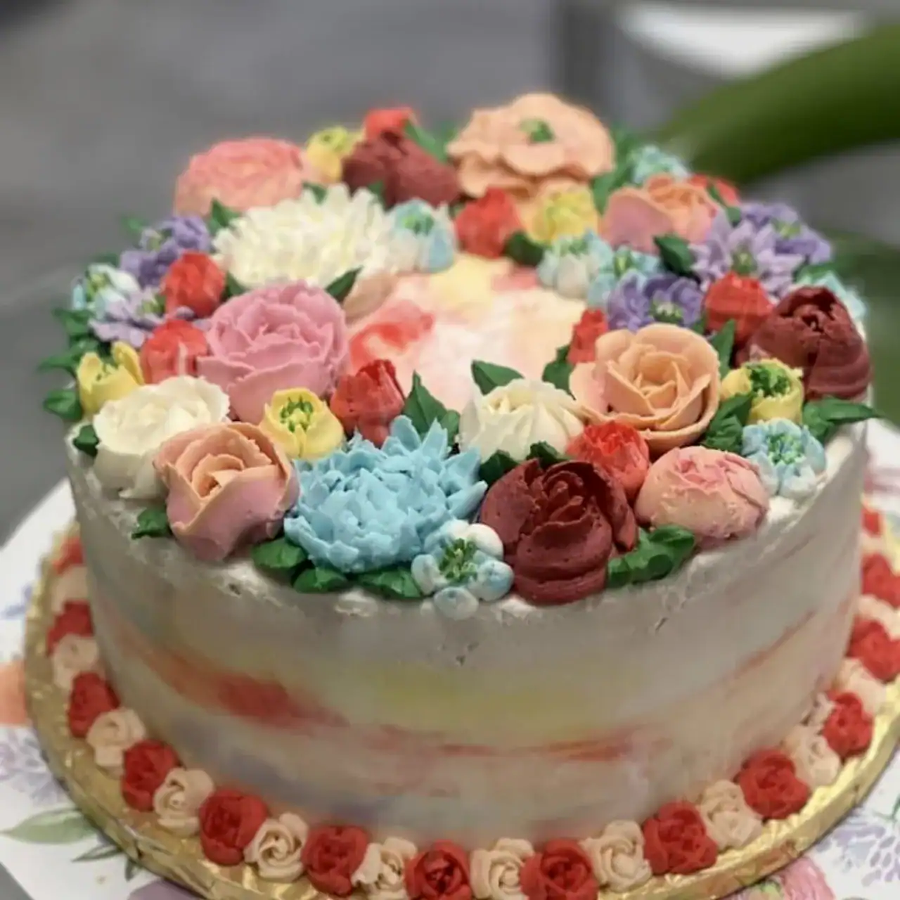Cake with colorful flower decorations and frosting details.