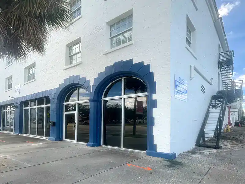Business storefront with large glass windows and blue decorative arches.