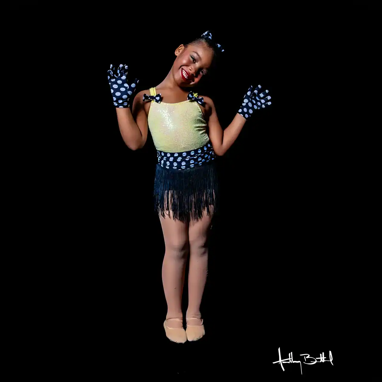 Girl in dance costume with gloves and skirt.
