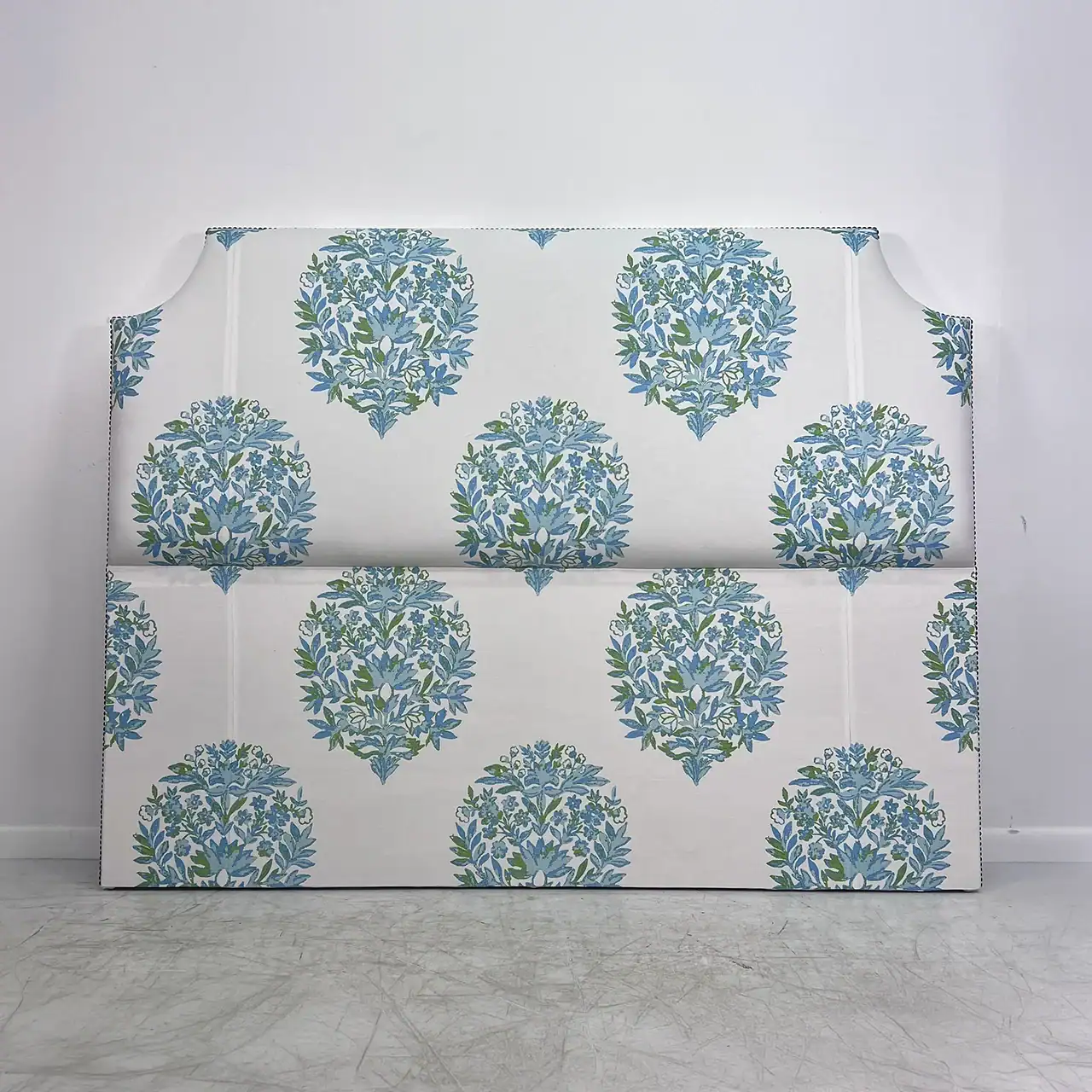 Headboard with a floral pattern in blue and green.