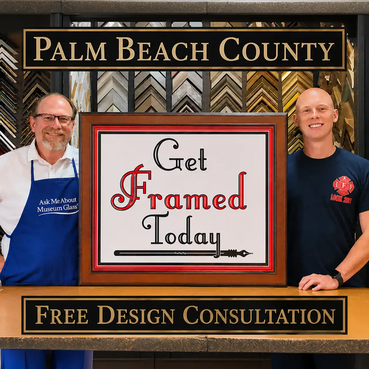 Artisans smiling with framed sign promoting custom framing services at Palm Beach County store.