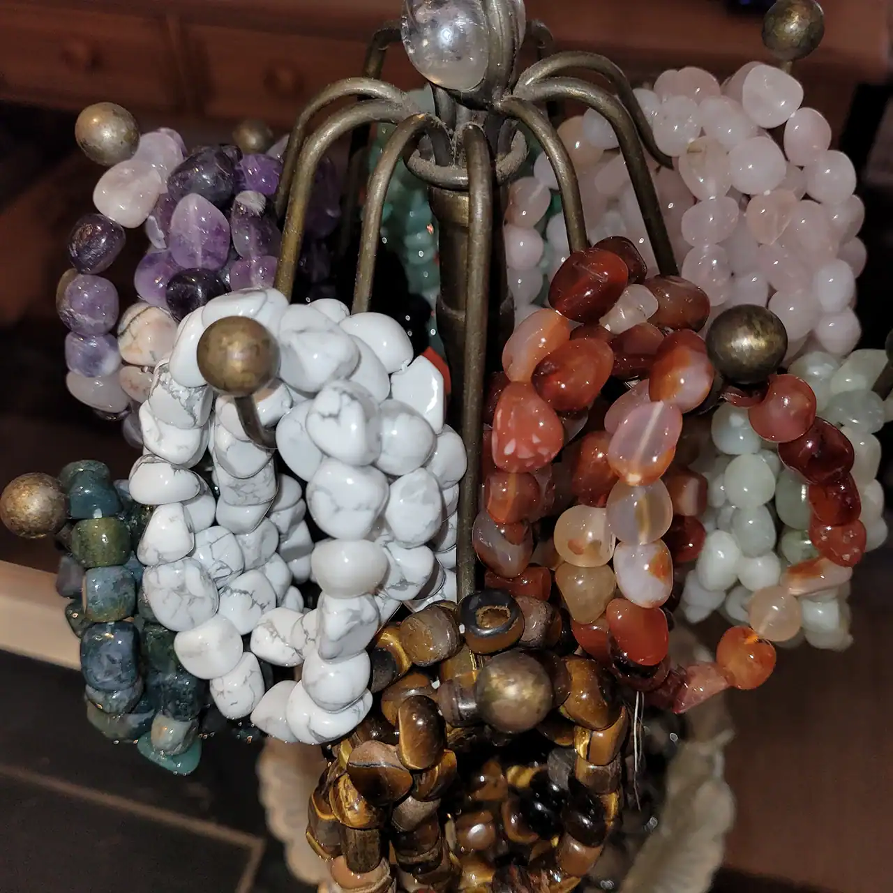 Bracelet jewelry display with various beaded accessories on a metal stand.
