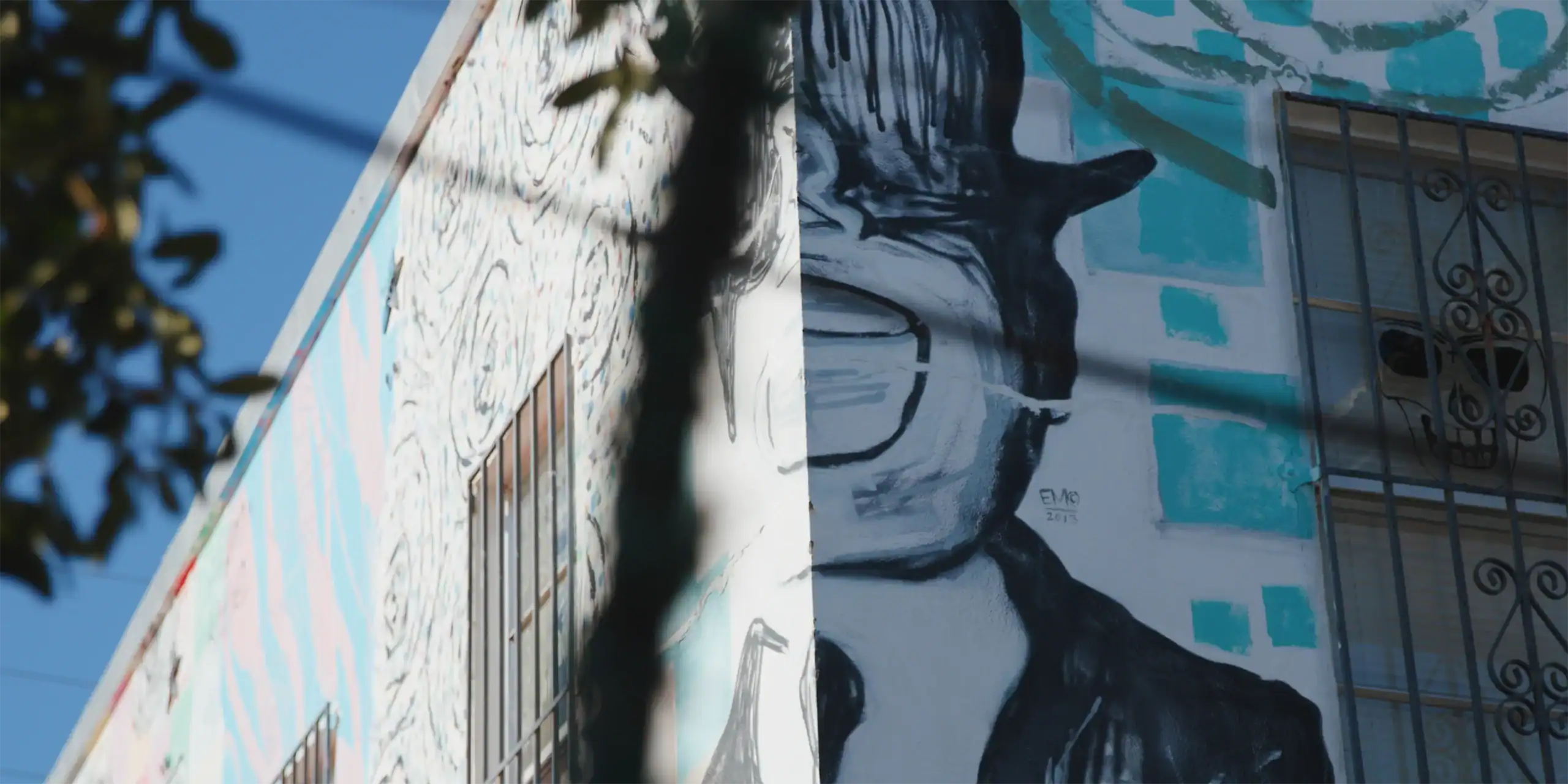 Street art mural of a woman with glasses and long hair.