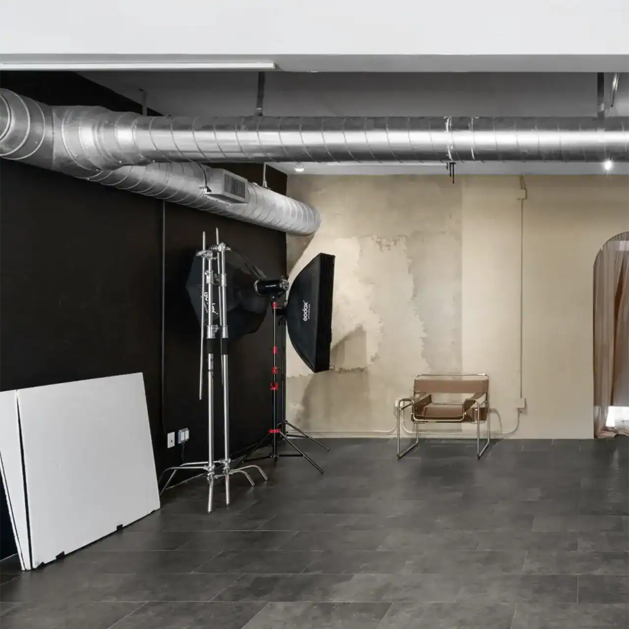 Photo studio lighting and backdrop equipment.