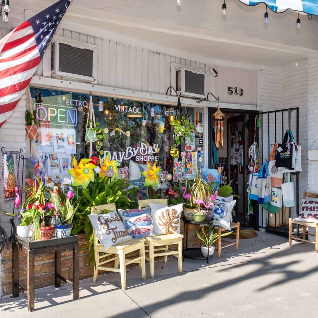 Vintage shop storefront with outdoor display and American flag.