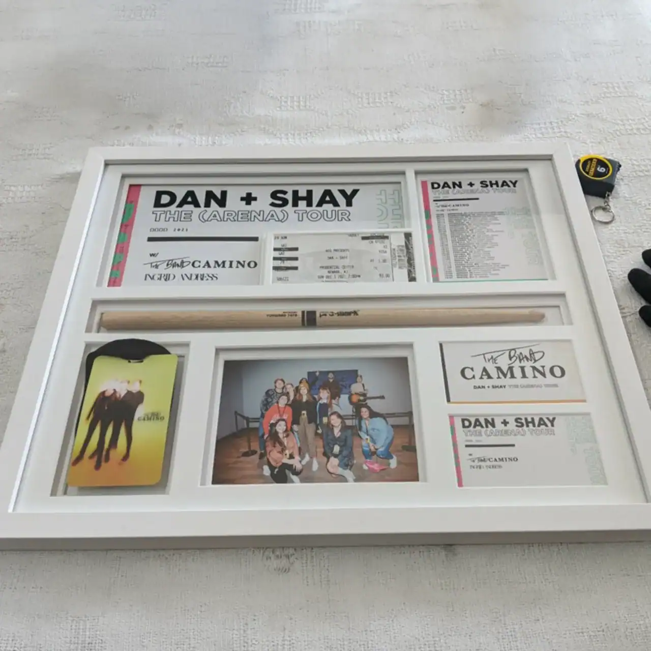 DAN + SHAY concert tickets and memorabilia display in a white frame.