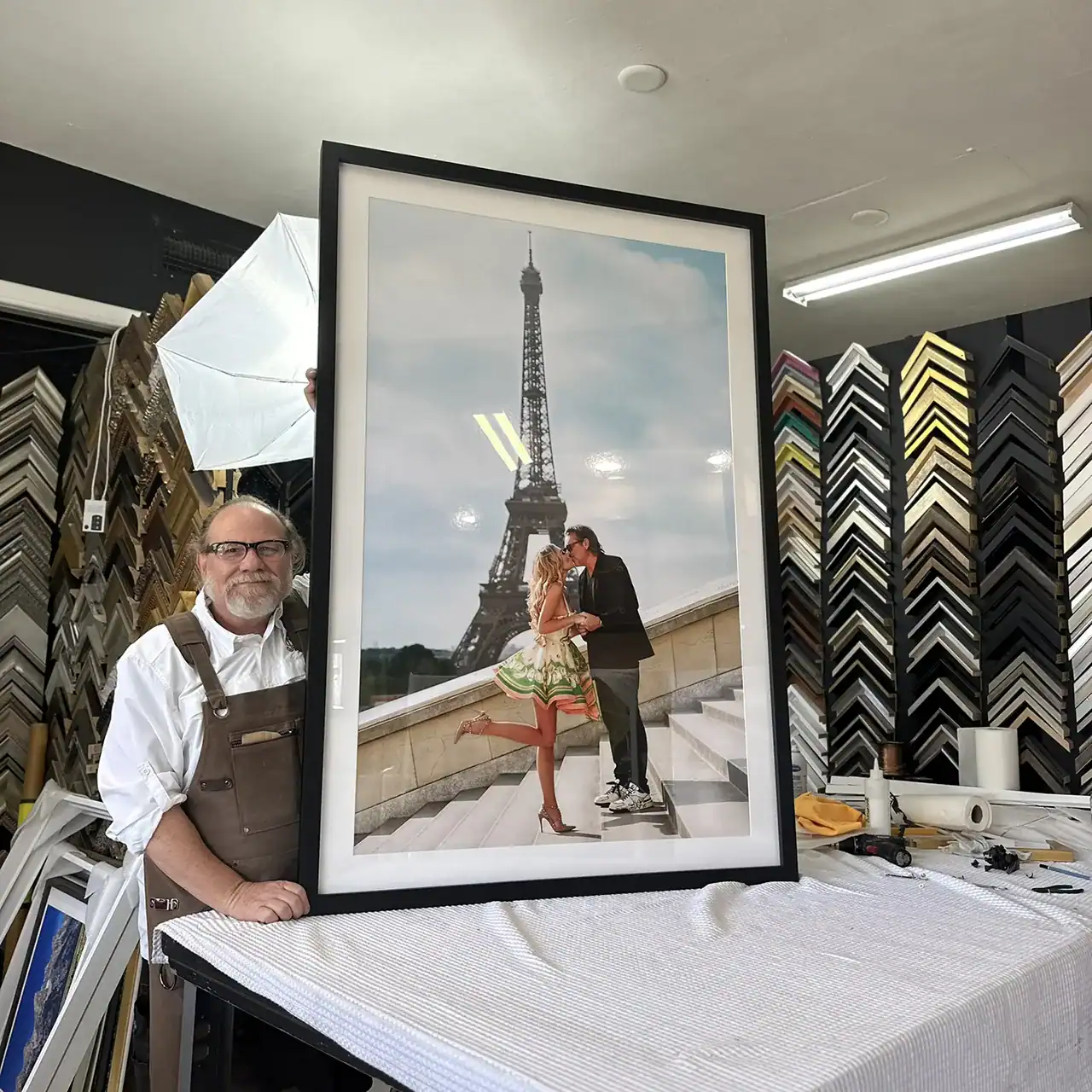 Framed photo of a couple kissing with Eiffel Tower in the background.
